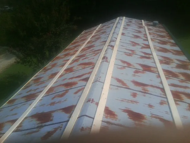 Rusted metal roof panels with new wood purlins before replacement — Storm Damage Roof Repair in Denair by Roofing Brothers